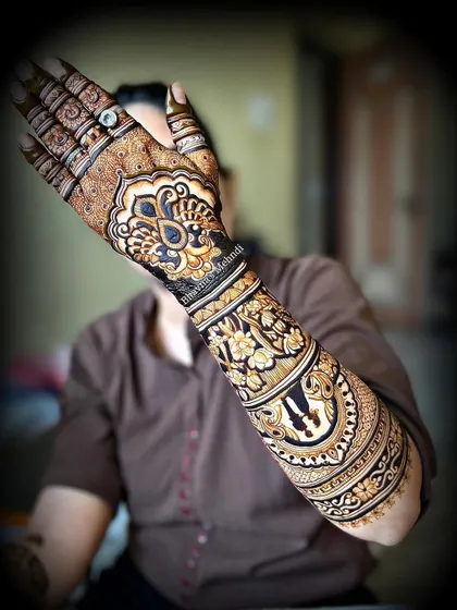 A stunning full arm design with bold, modern elements. The large central motif and surrounding patterns create a very striking look.