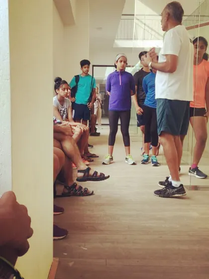 Our players listen intently as a coach explains the nuances of reflex training. These group discussions are a vital part of our coaching philosophy.