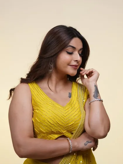 A sweet moment in the yellow draped saree. This outfit is not just stylish, it's also comfortable and easy to move in.
