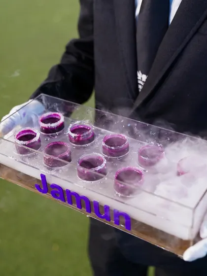 A tray of our signature Jamun Shots being served with dramatic flair, complete with dry ice for a smoky effect.