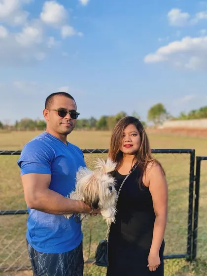 A sweet family photo with their little dog against the backdrop of our wide-open field.