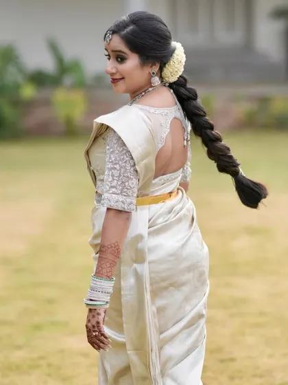The back view of the silver-embroidered blouse, showing its elegant design.