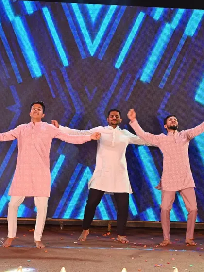 The groom's brothers and friends in a high-energy performance. We choreograph powerful and fun routines for the 'ladkewale' to bring their energy to the sangeet stage.