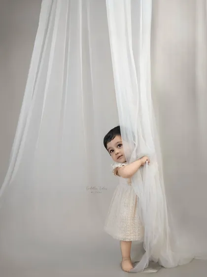 A shy, curious peek from behind the curtain. I take things slow and gentle, allowing little ones to get comfortable and let their true personalities emerge at their own pace.