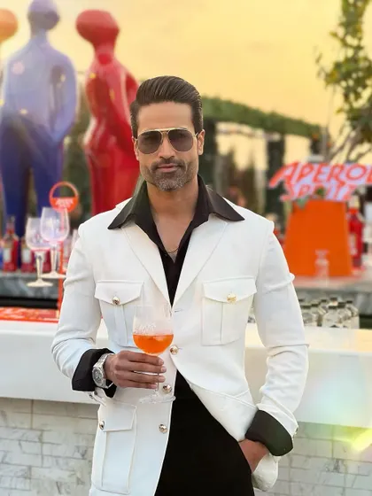 Enjoying a sunset cocktail in our white Viaggio jacket. The gold-button details on the pockets add a touch of luxury.