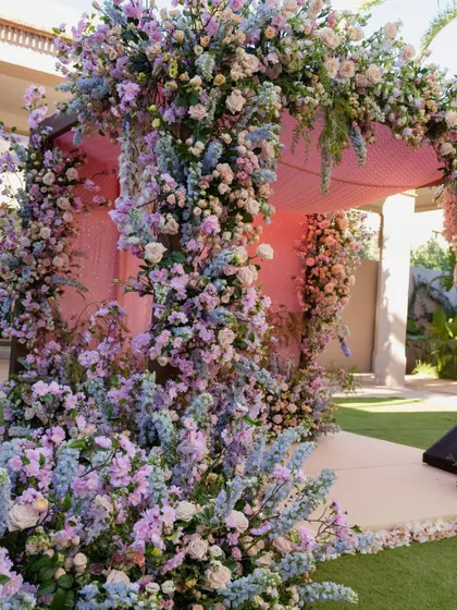 A close-up of the cascading flowers in shades of lilac, pink, and blue that adorned the Anand Karaj canopy.