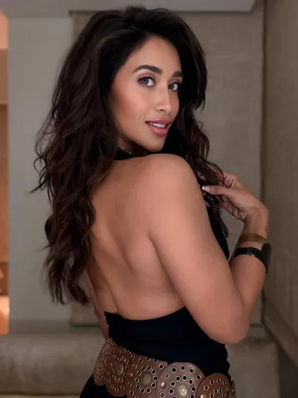 This deep brown two-tone color gives a rich and luxurious feel to long hair. The client's pose shows off the length and healthy shine of her new look.