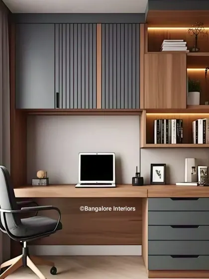 This compact home office design combines wood and dark gray fluted panels for a contemporary look. The layout includes overhead cabinets, open shelving, and drawers, providing plenty of storage in a small footprint.