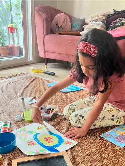 Another student deeply engaged in her Monet-inspired artwork. This technique of using wax to resist the watercolor paint creates such a magical reveal.