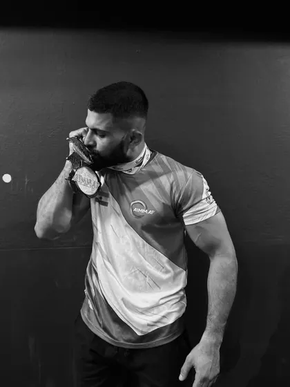 The taste of victory after countless hours of training. Shebin K Ibrahim with his medal, a testament to his champion mindset.