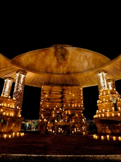 The grotto-style cave entrance, inspired by the Ajanta and Ellora caves. Thousands of candles created a warm, mystical pathway for guests to enter the main venue.