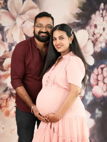 A lovely couple portrait against a floral backdrop. Their gentle smiles and close embrace make this a warm and beautiful memory of their time as parents-to-be.