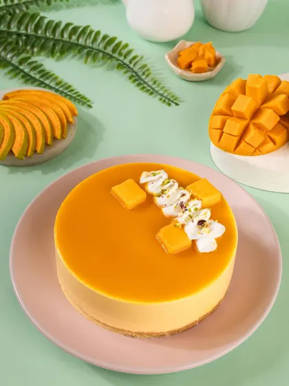 A top-down view of the mango cheesecake, highlighting the neat presentation and fresh garnish.