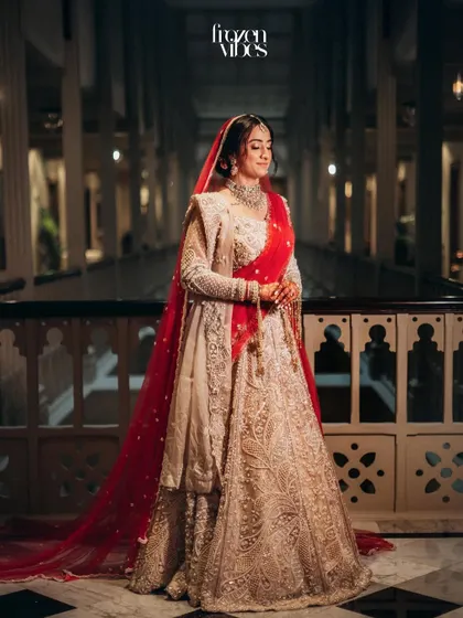 An elegant full-length portrait of the bride in the grand hallway. The classic setting complements her timeless bridal look perfectly.