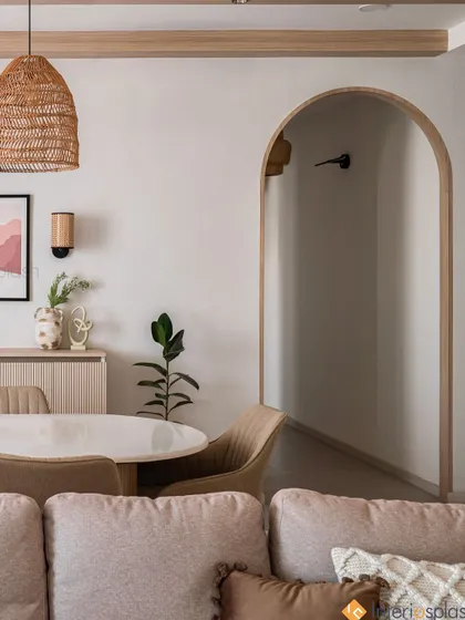 The arched doorway in this home creates a beautiful architectural feature, framing the view from the dining area into the hallway and adding a sense of depth and elegance.
