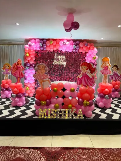This Barbie and princess-themed stage is all about pink and sparkle. We used a sequin backdrop, themed balloon columns, and character cutouts to create a glamorous setting for the birthday girl, Mishika.
