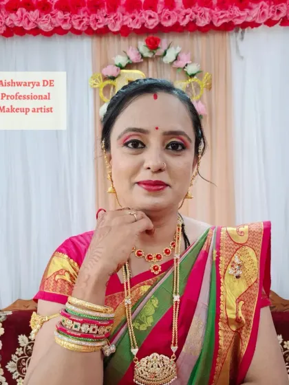 A happy client ready for her brother's engagement. I created a bright, festive look with a bold red lip and defined eyes that perfectly matched her colorful saree and jewelry.