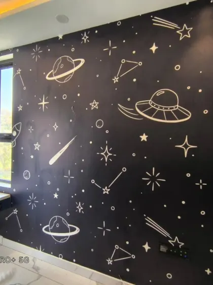 A contrasting space-themed wallpaper with white illustrations on a black background, creating a dramatic night-sky effect.