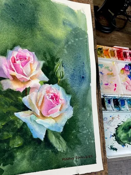 The pink rose painting shown on my easel, next to my palette. This gives a behind-the-scenes look at the colors I mixed to create the soft, multi-toned petals.