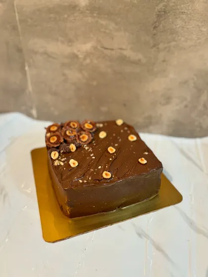 A square chocolate hazelnut cake, perfect for those who love a classic flavor combination with a modern shape.
