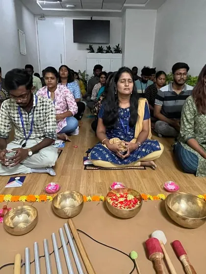 Another group from the Comcast wellness day, sitting in meditation. The room is filled with a sense of calm and focus, a welcome break from the demands of the corporate world.