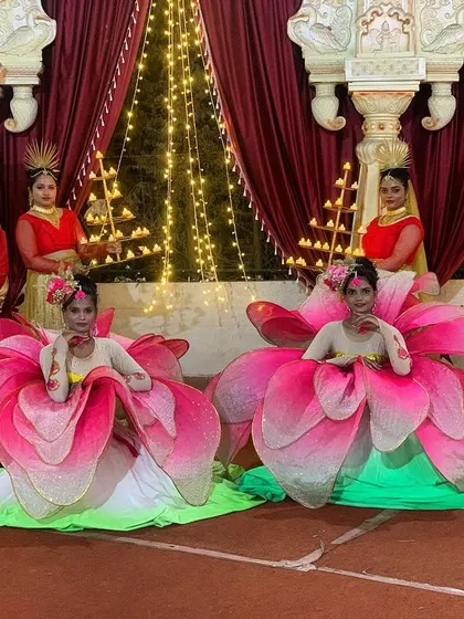 Our team is ready to create memories with a Lotus entry. This setup, featuring fan props, is perfect for welcoming the bride and groom to their reception.