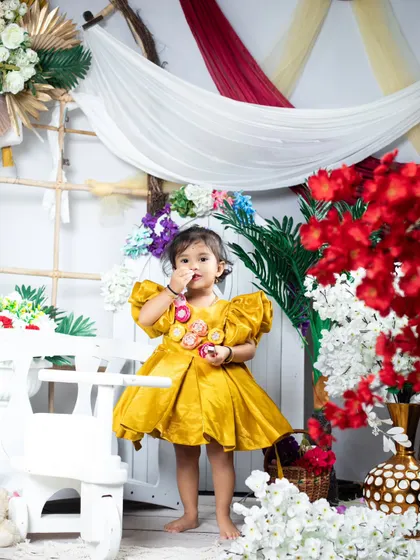 A full-length shot of the gorgeous yellow dress, surrounded by colorful flowers.