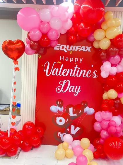 I also handle corporate event decorations. This photo booth for an office Valentine's Day party includes a branded backdrop and a festive red and pink balloon garland, creating a fun atmosphere for employees.