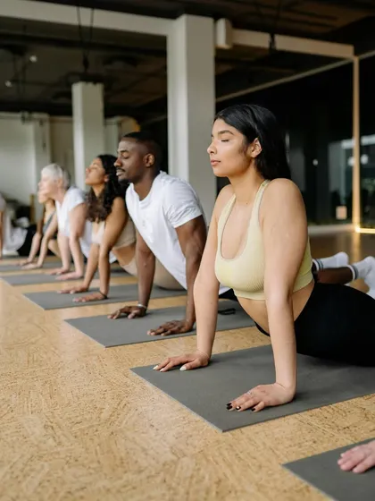Become a certified yoga instructor and start your journey toward personal fulfillment. This image from one of our group classes shows the supportive community you will be a part of.