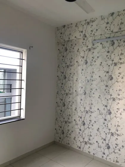 A delicate cherry blossom wallpaper installed as an accent wall in a bedroom in Chennai.