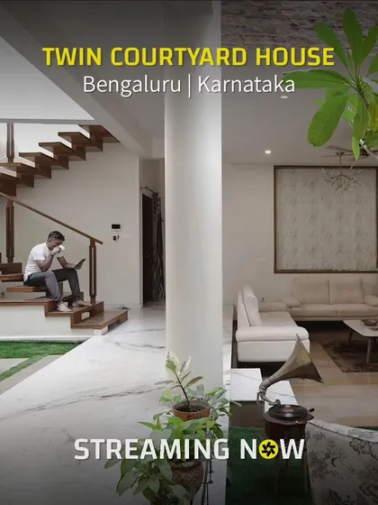 This promotional image captures the essence of the Twin Courtyard House, showing the living area, the unique staircase, and the central courtyard all in one frame. It highlights our ability to create multi-functional, interconnected spaces.