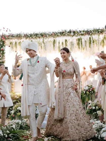 Another angle of their joyful walk. The natural lighting of the outdoor wedding makes her dewy makeup look even more beautiful.