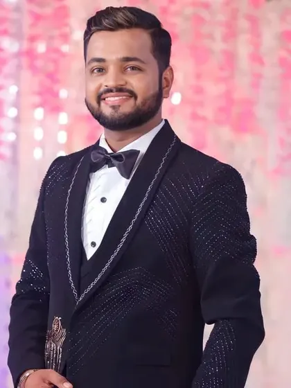 This groom is all smiles at his reception. The makeup is natural yet effective, giving him a fresh and polished look for the party.