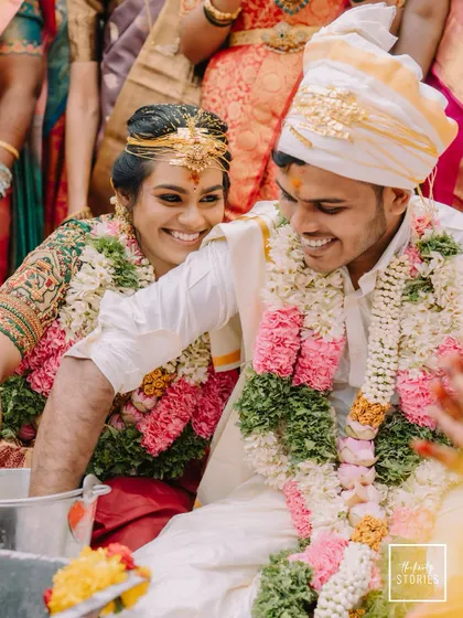 A candid moment of shared laughter during a wedding game. These playful rituals are an essential part of the celebration, and we love capturing the genuine smiles they bring.