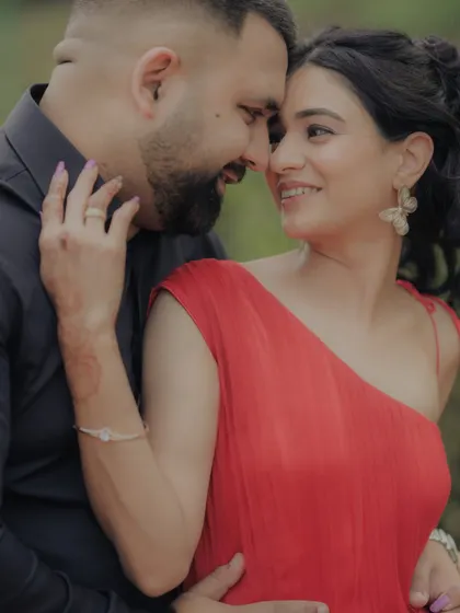 A close-up shot capturing the loving gaze between the couple. The woman's hand gently touching his face adds to the intimacy of this beautiful moment from their outdoor engagement shoot.