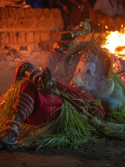 A series capturing the different stages of the Pottan Theyyam ritual, from the performer lying on the embers to being tended to by assistants. These images show the intensity and devotion involved in the all-night ceremony.
