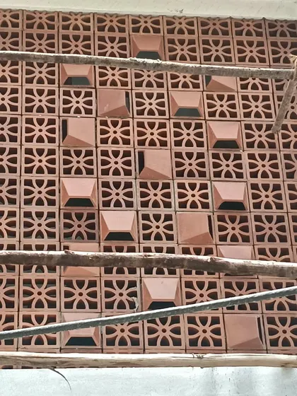A jali wall during the construction phase. We carefully place each block to create a seamless pattern, alternating designs to add a subtle, custom touch to the final feature wall.