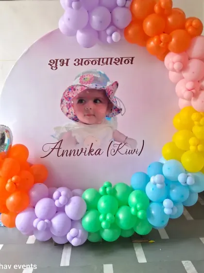 Another view of the rainbow-themed Annaprashan decoration, showing the full circular balloon arrangement.
