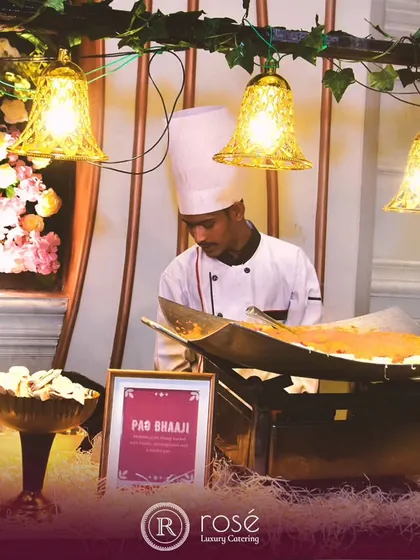 A chef prepares classic Pav Bhaji at a live station, complete with a large tawa for the bhaji and a space for toasting the buttery pav. This setup brings the bustling energy of Mumbai's street food scene to your event.