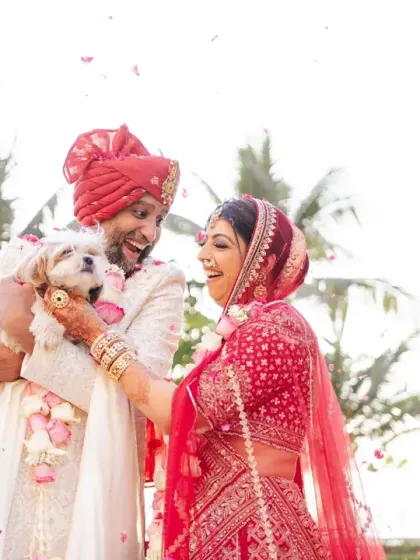 The couple shares a joyful moment with their adorable pet dog, who was part of the ceremony. This heartwarming photo shows that family comes in all forms.