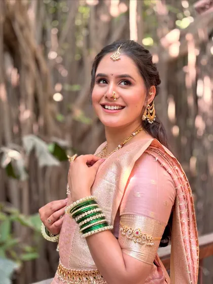 The perfect blend of tradition and joy. This bride's radiant look, featuring a soft pink saree and glowing makeup, was perfect for her outdoor wedding ceremony.
