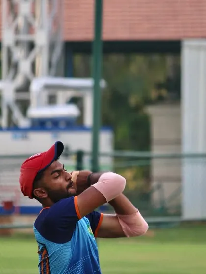 The follow-through of a high catch, showing the soft hands and focus required to secure the ball safely.