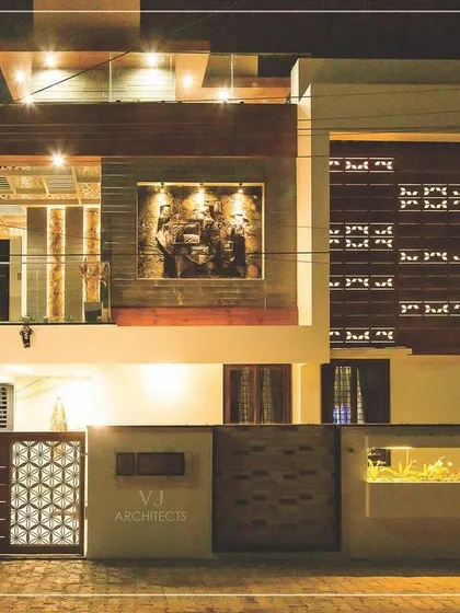 Our designs come alive after sunset. This night view of a Hubli residence highlights our approach to architectural lighting, where carefully placed lights accentuate the facade's textures, illuminate the integrated planters, and create a warm, welcoming, and secure ambiance.