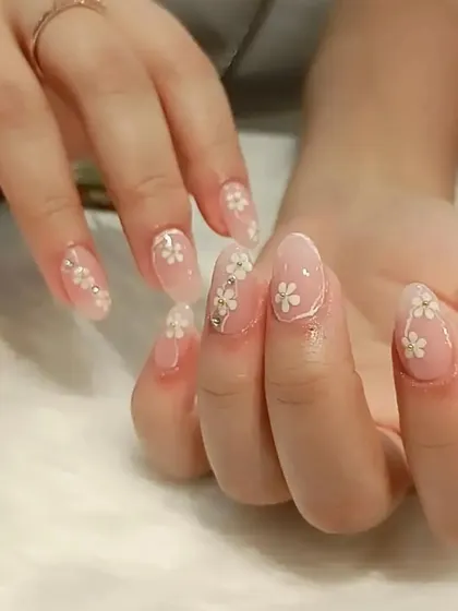 A soft and pretty design with tiny, delicate white flowers painted over a sheer, natural-looking base.