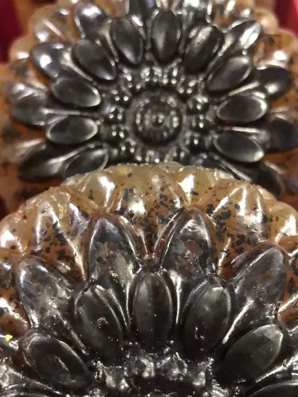 A close-up of my 'Wake Me Up' coffee scrub soap, fresh out of the mold. The dark coffee grounds contrast beautifully with the black and white soap base, creating a stunning sunflower pattern.