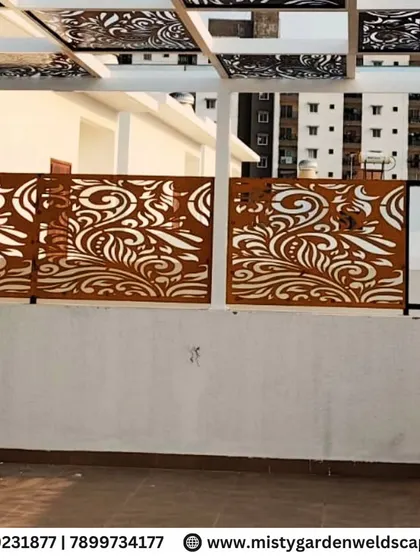 The beautiful rust-colored CNC panels stand out against the white wall, showcasing the artistic element of the pergola design at Natura Atavi. These panels provide both privacy and a stunning visual feature.