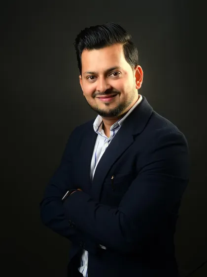 A classic professional pose with arms crossed. It's a universally understood sign of confidence and expertise, perfect for a business profile.