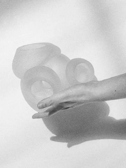 The beauty of the Bocci 100 series lies in its form, even when unlit. This black and white image highlights the sculptural quality and the delicate, hand-shaped nature of the glass.