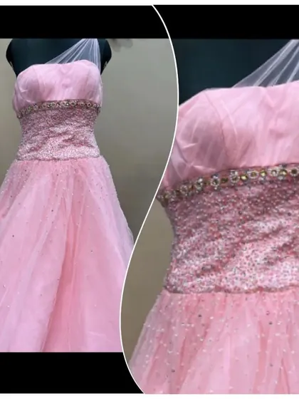 This pretty peach-pink gown features a heavily beaded and sequined bodice for a touch of sparkle. The one-shoulder tulle strap adds a modern, asymmetrical detail.