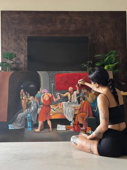 Another angle of me working on the large Socrates canvas. You can see my palette and brushes ready to go as I fill in the details.